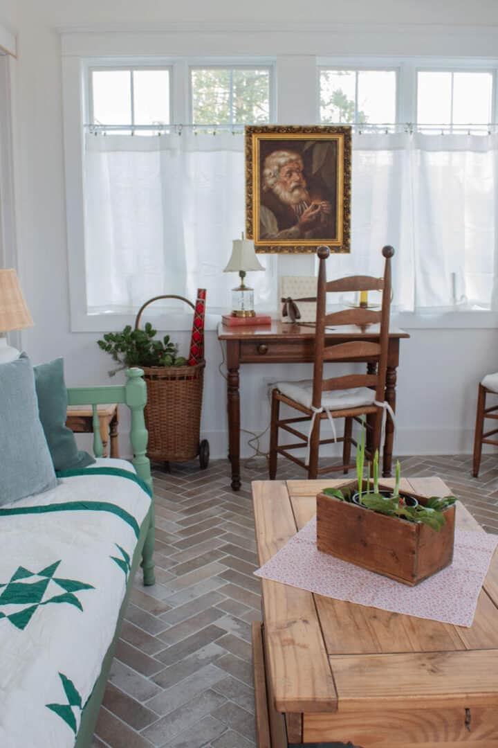 vintage Santa painting and vintage Christmas decorations in sunroom